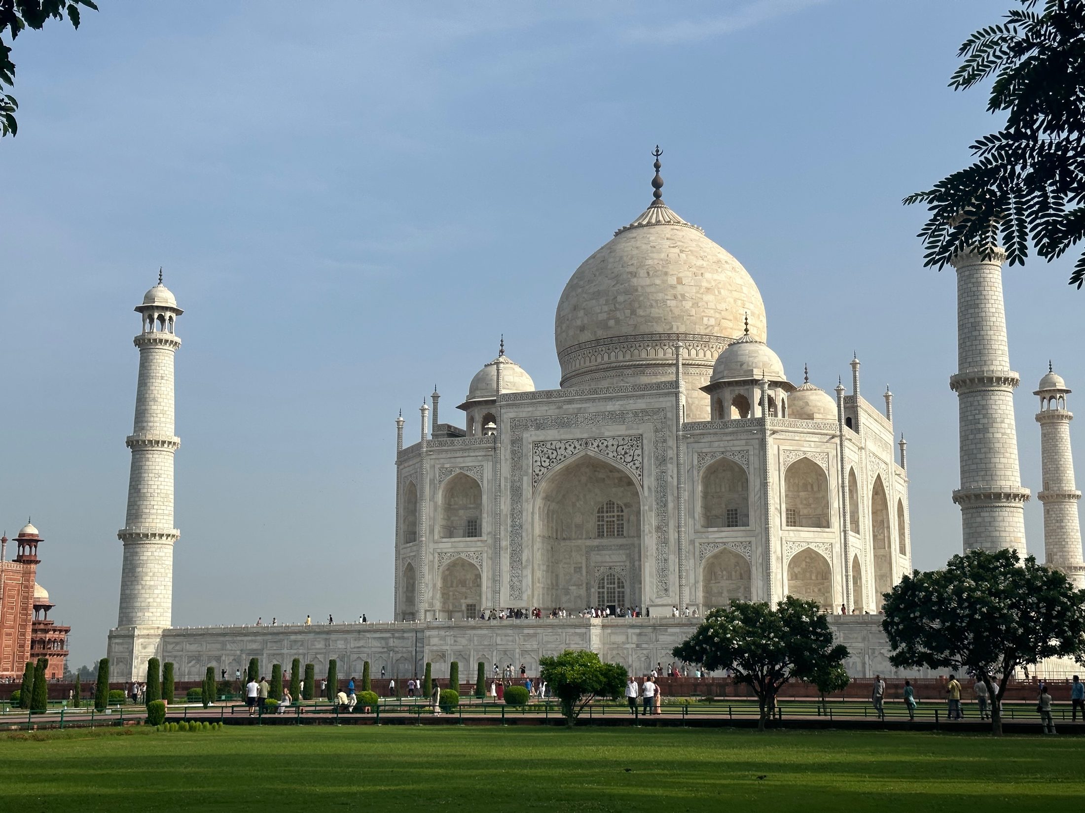 The Taj Mahal in white marble beneath a clear sky