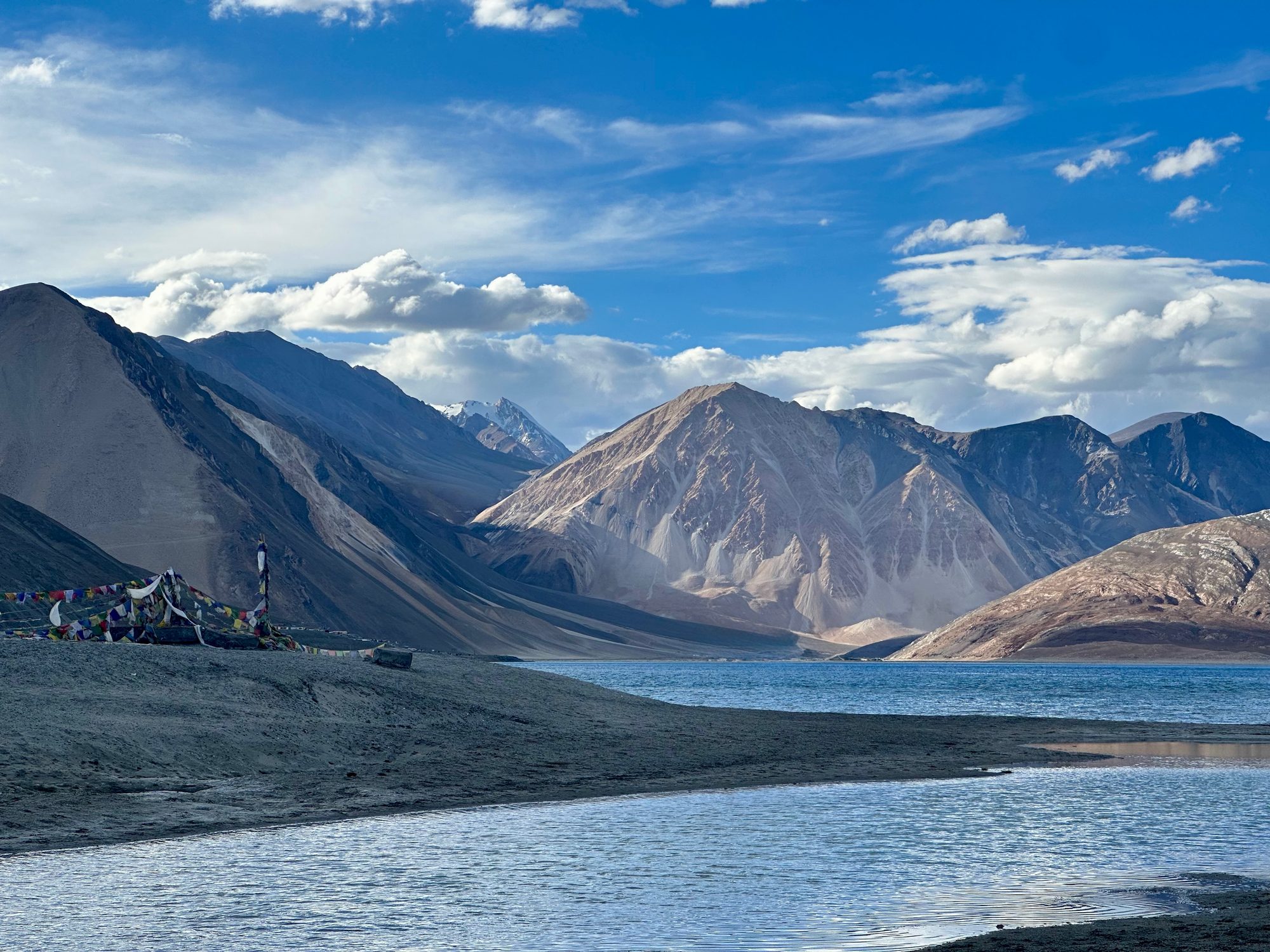 A deep blue high-altitude lake ringed by bare mountains