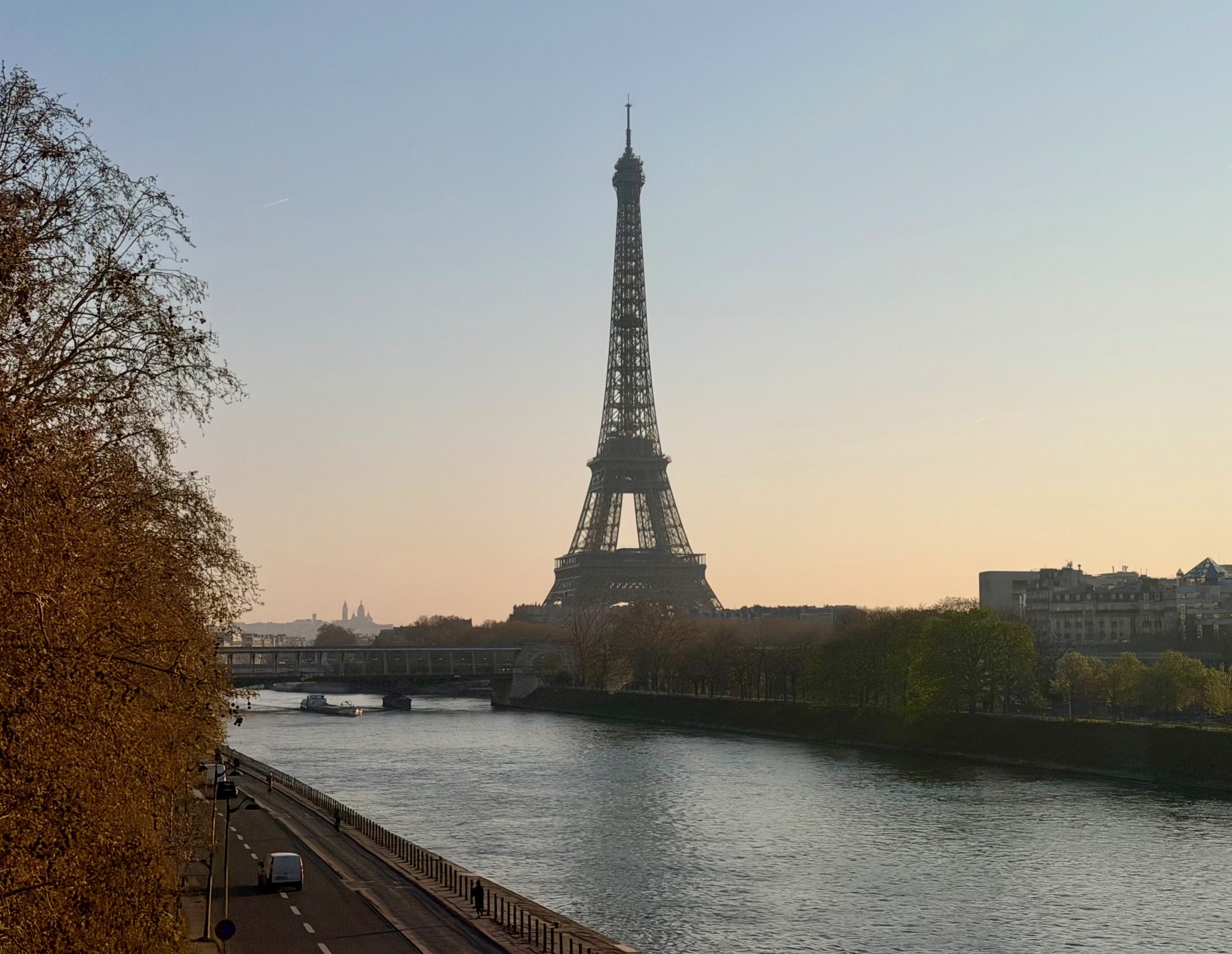 The Eiffel Tower above the Seine at dusk